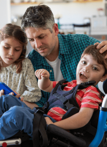 A father with his daughter and son with cerebral palsy